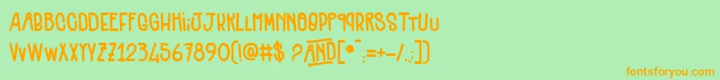 Quenelles-Schriftart – Orangefarbene Schriften auf grünem Hintergrund