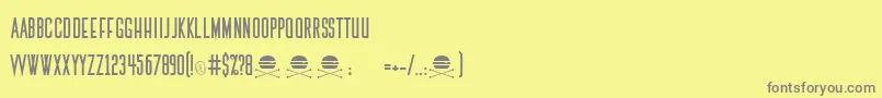 フォントThemedicRegular – 黄色の背景に灰色の文字