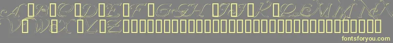 Шрифт Wrenninitialsembossed – жёлтые шрифты на сером фоне