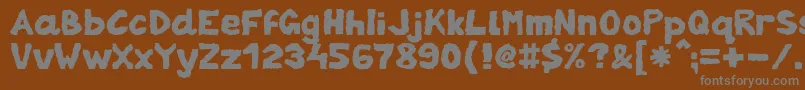 ZaiTornpaper-fontti – harmaat kirjasimet ruskealla taustalla