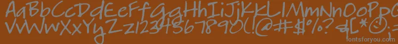 DjbHeatherg-fontti – harmaat kirjasimet ruskealla taustalla