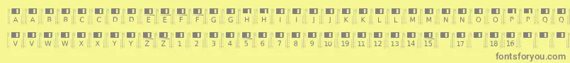 Floppydisk-fontti – harmaat kirjasimet keltaisella taustalla