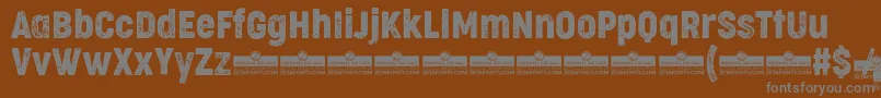 Шрифт CocogooseCondensedLetterpressTrial – серые шрифты на коричневом фоне