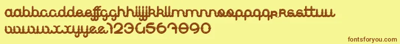 フォントJeansDeNimes – 茶色の文字が黄色の背景にあります。