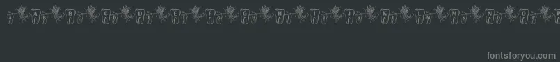 フォントToothFairy – 黒い背景に灰色の文字