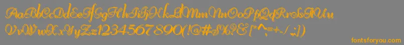 フォントReliantShadowFree – オレンジの文字は灰色の背景にあります。