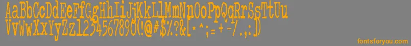 フォントColourMePurple – オレンジの文字は灰色の背景にあります。
