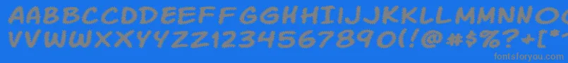 Komikatr-Schriftart – Graue Schriften auf blauem Hintergrund