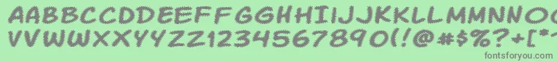 Komikatr Font – Gray Fonts on Green Background