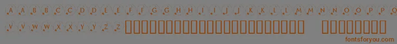 フォントKrHappyNewYear2002 – 茶色の文字が灰色の背景にあります。