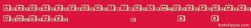 TinyTube-Schriftart – Grüne Schriften auf rotem Hintergrund