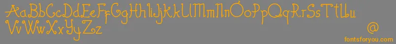フォントThewambiresdemo – オレンジの文字は灰色の背景にあります。