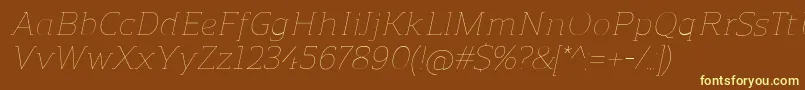 ReganslabUltralightitalic-fontti – keltaiset fontit ruskealla taustalla