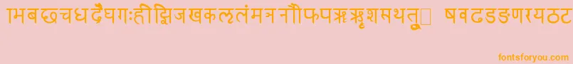 フォントRkSanskrit – オレンジの文字がピンクの背景にあります。