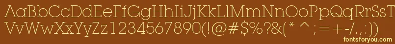 LubalinGraphExtraLightBt-fontti – keltaiset fontit ruskealla taustalla