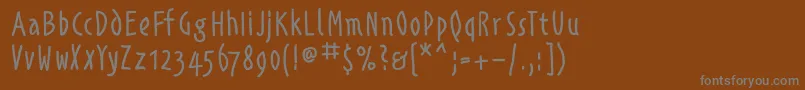 Alphabetismhand-Schriftart – Graue Schriften auf braunem Hintergrund