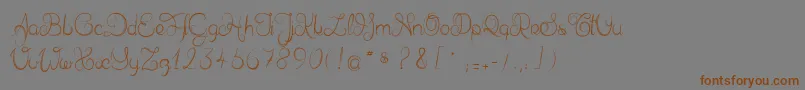 フォントDelphineetmathiasscript – 茶色の文字が灰色の背景にあります。