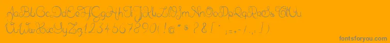 フォントDelphineetmathiasscript – オレンジの背景に灰色の文字