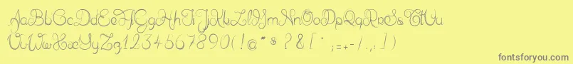 Delphineetmathiasscript-fontti – harmaat kirjasimet keltaisella taustalla