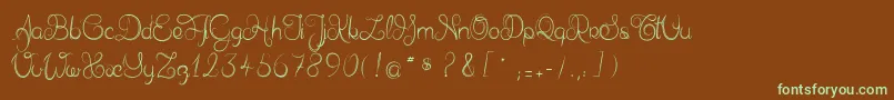 フォントDelphineetmathiasscript – 緑色の文字が茶色の背景にあります。