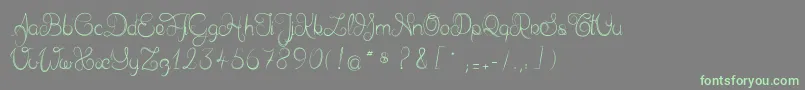 フォントDelphineetmathiasscript – 灰色の背景に緑のフォント