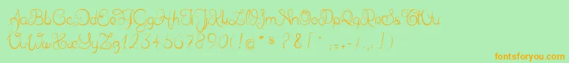 フォントDelphineetmathiasscript – オレンジの文字が緑の背景にあります。