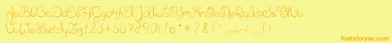 フォントDelphineetmathiasscript – オレンジの文字が黄色の背景にあります。