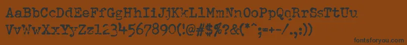 Pfdumboldtypetwo-Schriftart – Schwarze Schriften auf braunem Hintergrund
