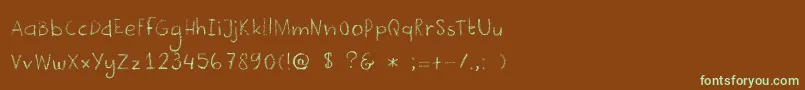 フォントDkCrayonista – 緑色の文字が茶色の背景にあります。