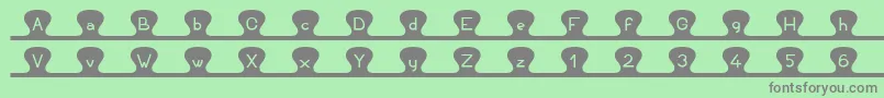 Unzipme-fontti – harmaat kirjasimet vihreällä taustalla