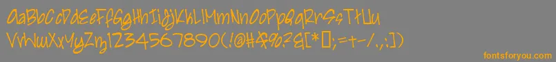フォントIrezumi – オレンジの文字は灰色の背景にあります。