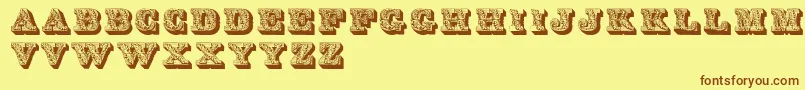 フォントLettresOmbreesOrnees – 茶色の文字が黄色の背景にあります。