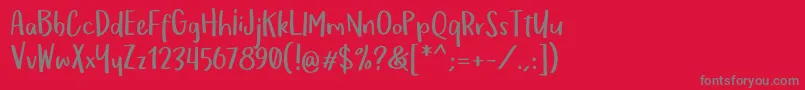 フォントOmTeloletOm – 赤い背景に灰色の文字