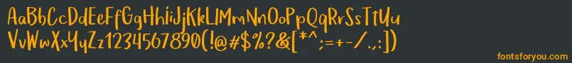 フォントOmTeloletOm – 黒い背景にオレンジの文字