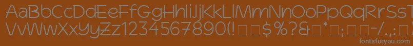 DinkoSsi-fontti – harmaat kirjasimet ruskealla taustalla