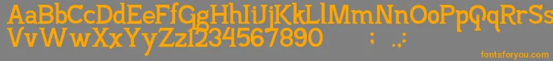 フォントPajarakanStuds – オレンジの文字は灰色の背景にあります。