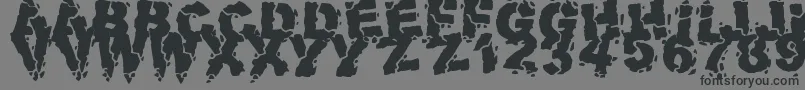 フォントVolcanicDungeon – 黒い文字の灰色の背景