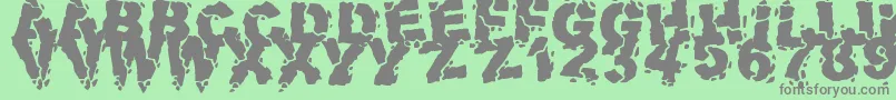 VolcanicDungeon-Schriftart – Graue Schriften auf grünem Hintergrund