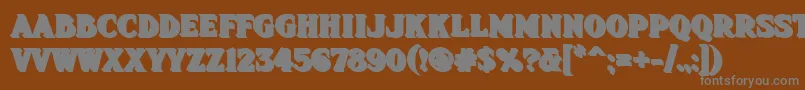 Fhadevshnc-fontti – harmaat kirjasimet ruskealla taustalla