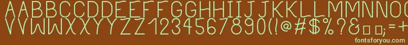 フォントPhilippineRegular – 緑色の文字が茶色の背景にあります。