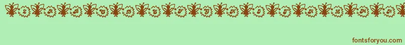 Czcionka FairySparkle – brązowe czcionki na zielonym tle
