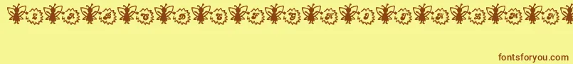 Czcionka FairySparkle – brązowe czcionki na żółtym tle