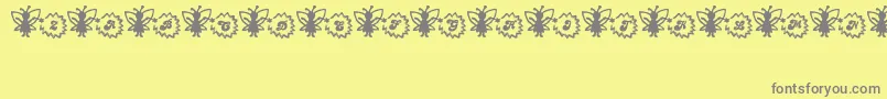 FairySparkle-Schriftart – Graue Schriften auf gelbem Hintergrund