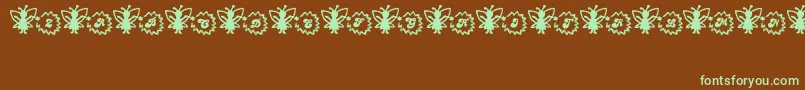 Czcionka FairySparkle – zielone czcionki na brązowym tle