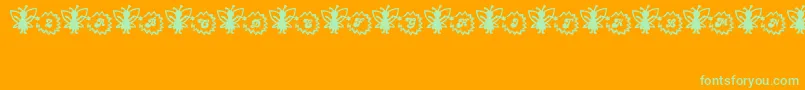 Czcionka FairySparkle – zielone czcionki na pomarańczowym tle