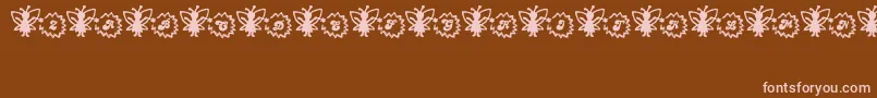 フォントFairySparkle – 茶色の背景にピンクのフォント