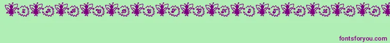 Czcionka FairySparkle – fioletowe czcionki na zielonym tle