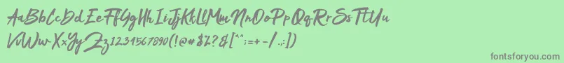 フォントMakDah – 緑の背景に灰色の文字