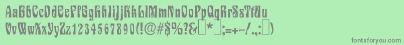 S730DecoRegular-fontti – harmaat kirjasimet vihreällä taustalla