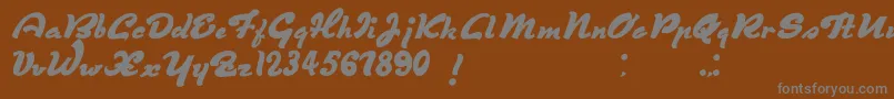 フォントDerniereScript – 茶色の背景に灰色の文字